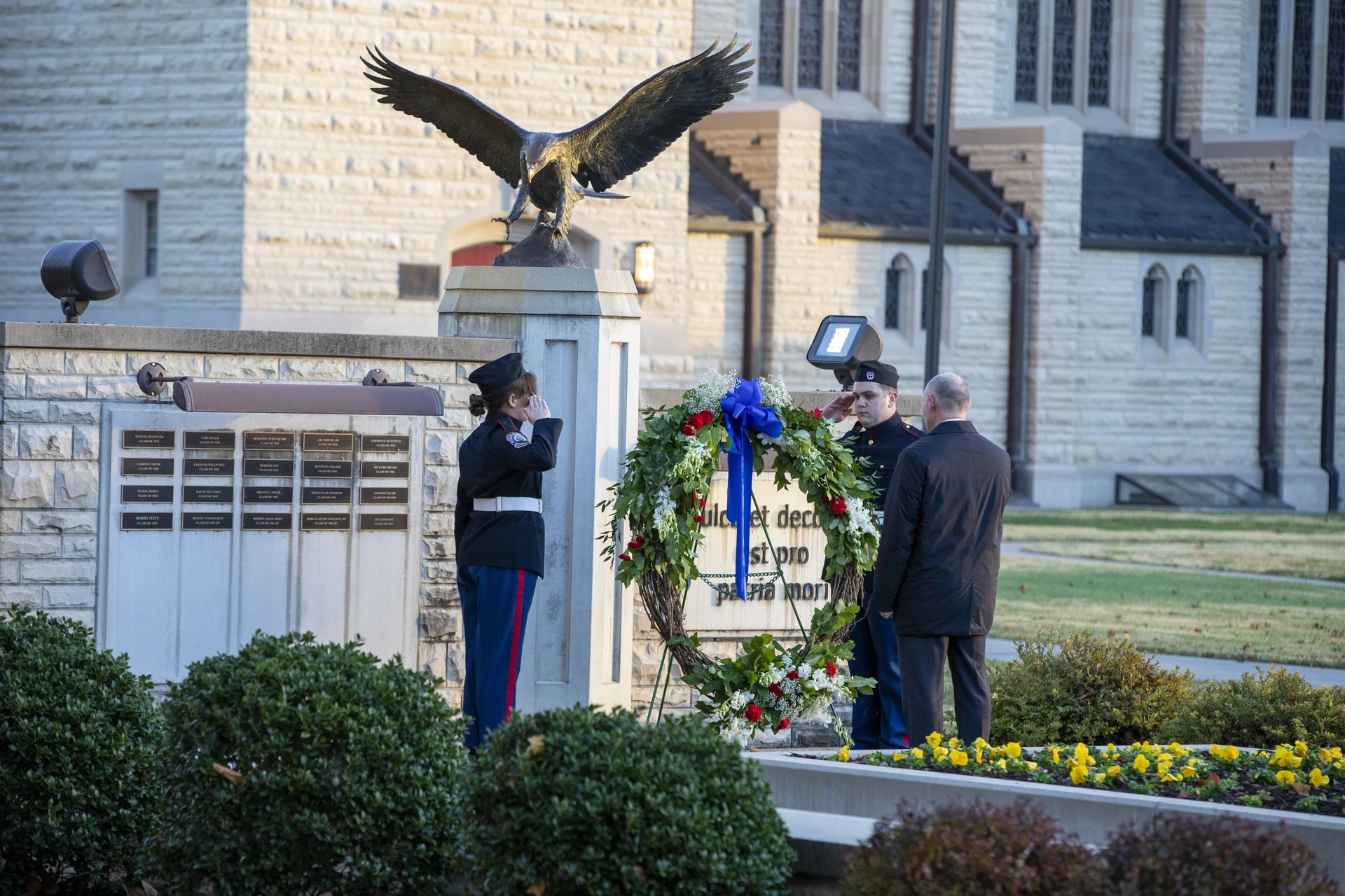 men laying wreath